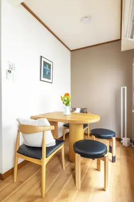 a dining room with a table and two chairs at Home suite Home Ryogoku - Perfect for Families and Groups, Spacious 197m2 Home with 8 BR & 3 BA, Up to 15 ppl with Parking and 3 Stations in Tokyo