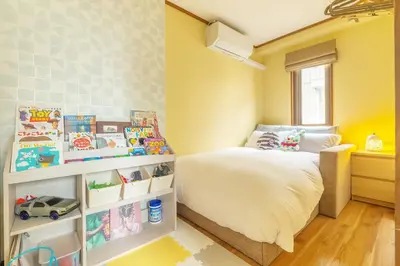 a small bedroom with a bed and a window at Home suite Home Ryogoku - Perfect for Families and Groups, Spacious 197m2 Home with 8 BR & 3 BA, Up to 15 ppl with Parking and 3 Stations in Tokyo