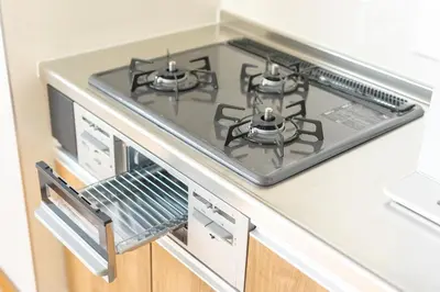 a kitchen with a stove top oven in a kitchen at Home suite Home Ryogoku - Perfect for Families and Groups, Spacious 197m2 Home with 8 BR & 3 BA, Up to 15 ppl with Parking and 3 Stations in Tokyo