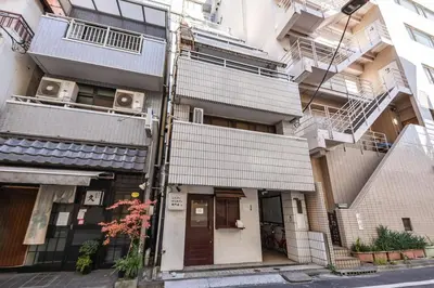 a building on a city street with a building at \u30b5\u30f3\u30ef\u30a4\u30c9\u9ad8\u6a4b\u30d3\u30eb in Tokyo