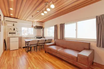 a living room with a couch and a table at V Close to Shinjuku Kabukicho Korean Town FrWIFI M in Tokyo
