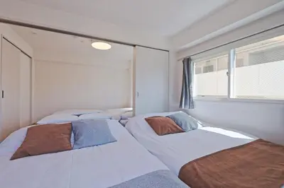 two beds in a bedroom with a window at V Close to Shinjuku Kabukicho Korean Town FrWIFI M in Tokyo