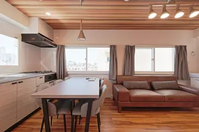 a kitchen and living room with a table and a couch at V Close to Shinjuku Kabukicho Korean Town FrWIFI M in Tokyo