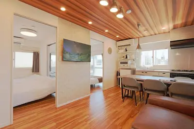 a room with a bed and a dining table and chairs at V Close to Shinjuku Kabukicho Korean Town FrWIFI M in Tokyo