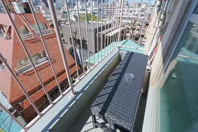 a bench on the balcony of a building at V Close to Shinjuku Kabukicho Korean Town FrWIFI M in Tokyo