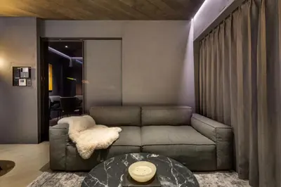 a living room with a couch and a table at THE LIVRE Apartment Hotel in Tokyo