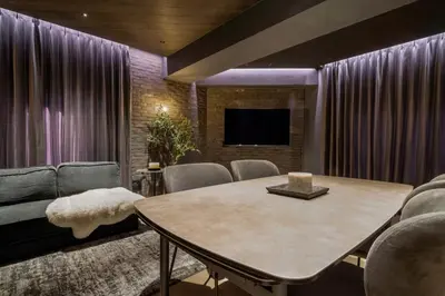a living room with a table and a couch at THE LIVRE Apartment Hotel in Tokyo
