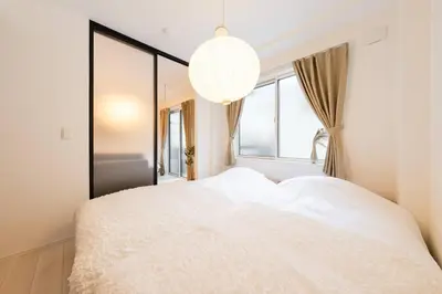 a bedroom with a white bed and a large window at House hotel EKODA 101 HE11 in Tokyo