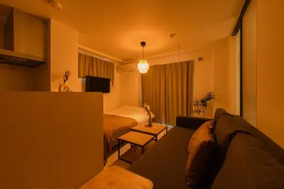 a living room with a bed and a couch in a room at House hotel EKODA 101 HE11 in Tokyo