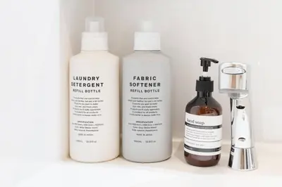 three bottles of hair products sitting on a shelf at House hotel EKODA 101 HE11 in Tokyo