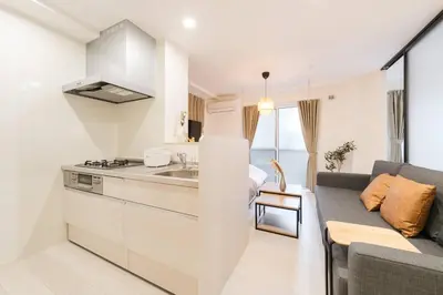a kitchen and living room with a couch and a stove at House hotel EKODA 101 HE11 in Tokyo