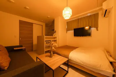 a hotel room with a bed and a couch at House hotel EKODA 101 HE11 in Tokyo