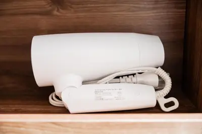 a white phone sitting on top of a shelf at Tabiya Shinamachi - New built APT at Ikebukuro, Relaxing Stay in Central Tokyo in Tokyo