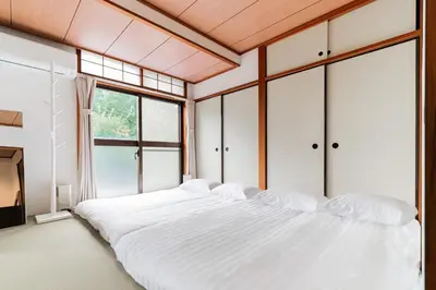 a large white bed in a room with windows at Luce Ikebukuro - Cozy APT Stay in Ikebukuro Tokyo, with Direct Access to Shinjuku & Shibuya in Tokyo