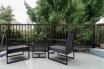 two chairs and a table next to a fence at Luce Ikebukuro - Cozy APT Stay in Ikebukuro Tokyo, with Direct Access to Shinjuku & Shibuya in Tokyo