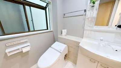 a white bathroom with a toilet and a sink at \u30db\u30c6\u30ebYado SK \u65b0\u5c0f\u5ca9 \u99c5\u5f92\u6b694\u5206 in Tokyo
