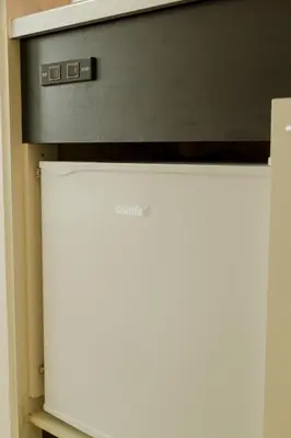 a television sitting on top of a white refrigerator at Ikebukuro 302 - Twin Room in Tokyo