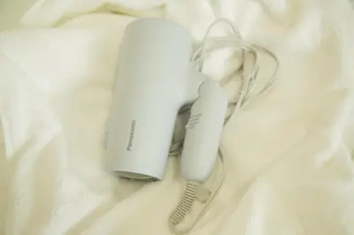 a nintendo wii game controller sitting on a white blanket at Ikebukuro 302 - Twin Room in Tokyo