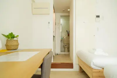 a bedroom with a desk and a bathroom with a toilet at Ikebukuro 302 - Twin Room in Tokyo