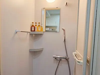 a bathroom with a shower with a mirror at \u5927\u5c71\u99c5\u5f92\u6b698\u5206 \u6c60\u888b\u307e\u3067\u96fb\u8eca\u30675\u5206 \u6700\u59276\u4eba\u5bbf\u6cca in Tokyo