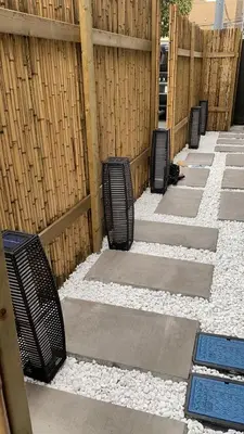 a row of black chairs sitting next to a fence at \u5fa1\u4eac\u30db\u30c6\u30eb in Tokyo
