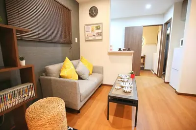 a living room with a couch and a table at \u5fa1\u4eac\u30db\u30c6\u30eb in Tokyo