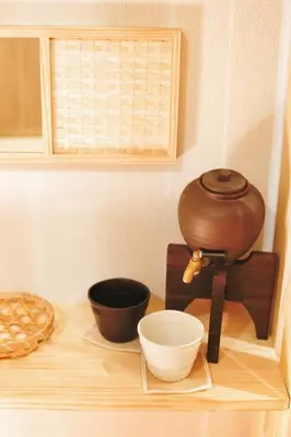 a mortar and pestle sitting on a counter with bowls at \u5fa1\u4eac\u30db\u30c6\u30eb in Tokyo