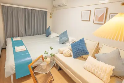 a small room with two beds and a couch at Near Shinjuku Nakano unit 3 Walking 4 Mins Broadway No2 in Tokyo