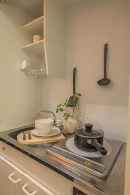 a kitchen with a stove with a pot on it at Near Shinjuku Nakano unit 3 Walking 4 Mins Broadway No2 in Tokyo