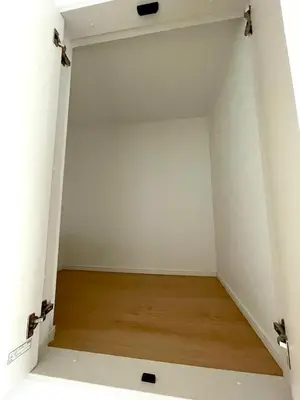 a room with a white wall and a wooden floor at MU HOUSE Ikebukuro \u6c60\u888b\u99c5\u8eca1\u5206 in Tokyo