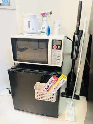 a microwave oven sitting on top of a refrigerator at Hot Deal! Simple, no-frills room 3 guest in Tokyo