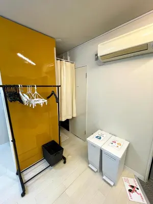 a bathroom with a shower and a yellow wall at Hot Deal! Simple, no-frills room 3 guest in Tokyo
