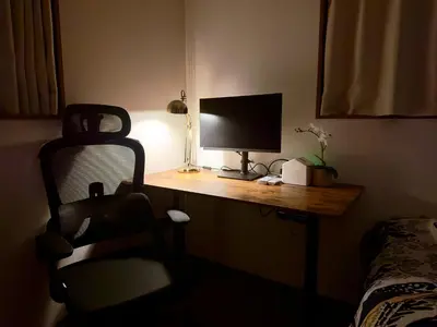 a room with a desk with a computer monitor and a chair at Hao Bros Home Gemini in Tokyo