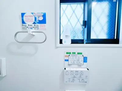 a bathroom with a thermometer on a wall with a window at Hao Bros Home Gemini in Tokyo