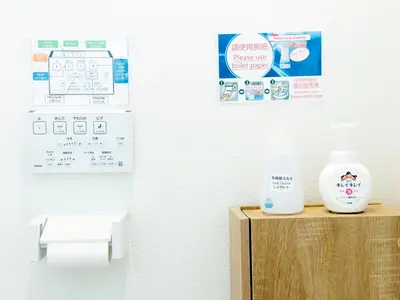 a bathroom with a bottle of soap on a wooden box at Hao Bros Home Gemini in Tokyo