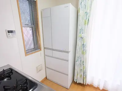 a kitchen with a stove and a white cabinet at Four Seasons Yado 2 in Tokyo