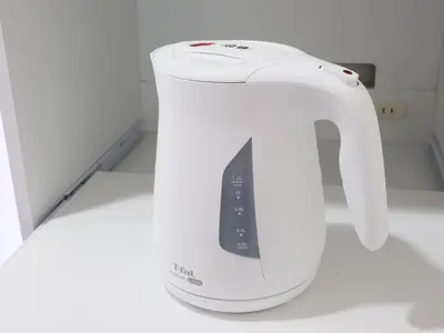 a white electric kettle sitting on a kitchen counter at Four Seasons Yado 2 in Tokyo