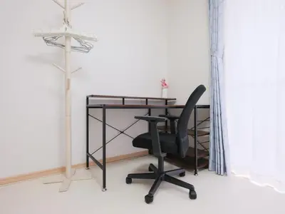 a desk with a chair and a lamp in a room at Four Seasons Yado 2 in Tokyo