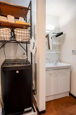 a small kitchen with a sink and a shelf at \u7573\u306e\u9593\u6c60\u888b in Tokyo
