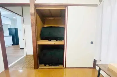 a room with a tv in a cabinet with a television at \u7573\u306e\u9593\u6c60\u888b in Tokyo