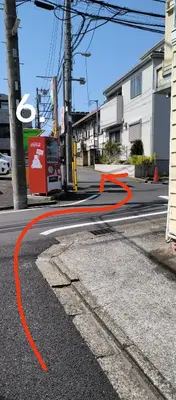 an orange line on a street with a city at \u548c\u98ce\u5c45 in Tokyo