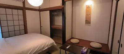 a small room with a bed and a table at \u548c\u98ce\u5c45 in Tokyo