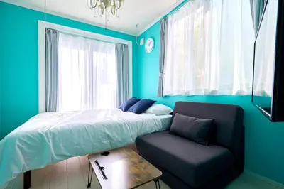 a bedroom with a bed and a chair and a window at K1 4min from nearest station 7min to shinjuku area101 in Tokyo