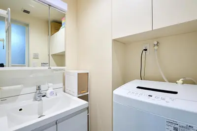a white bathroom with a sink and a mirror at K1 4min from nearest station 7min to shinjuku area101 in Tokyo