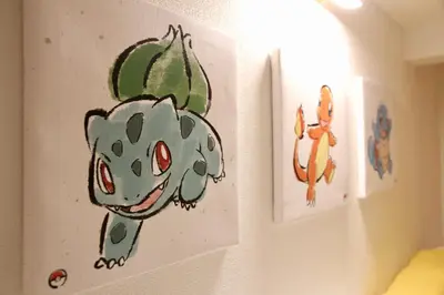 a drawing of a cactus on a wall next to two pictures at Fun Haven Itabashi in Tokyo
