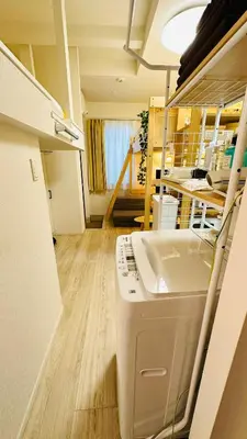 a kitchen with a washing machine in a room at Fun Haven Itabashi in Tokyo