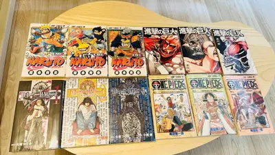 a pile of comic books on a wooden table at Fun Haven Itabashi in Tokyo
