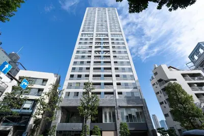 a tall white building with trees in front of it at \u6771\u6025\u30b9\u30c6\u30a4\u9752\u5c71 in Tokyo