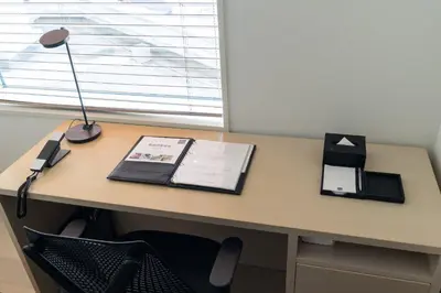 a desk with a lamp and a book on it at \u6771\u6025\u30b9\u30c6\u30a4\u9752\u5c71 in Tokyo