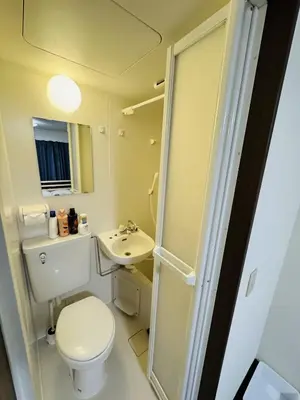 a bathroom with a toilet and a sink at Toho so Inn in Tokyo